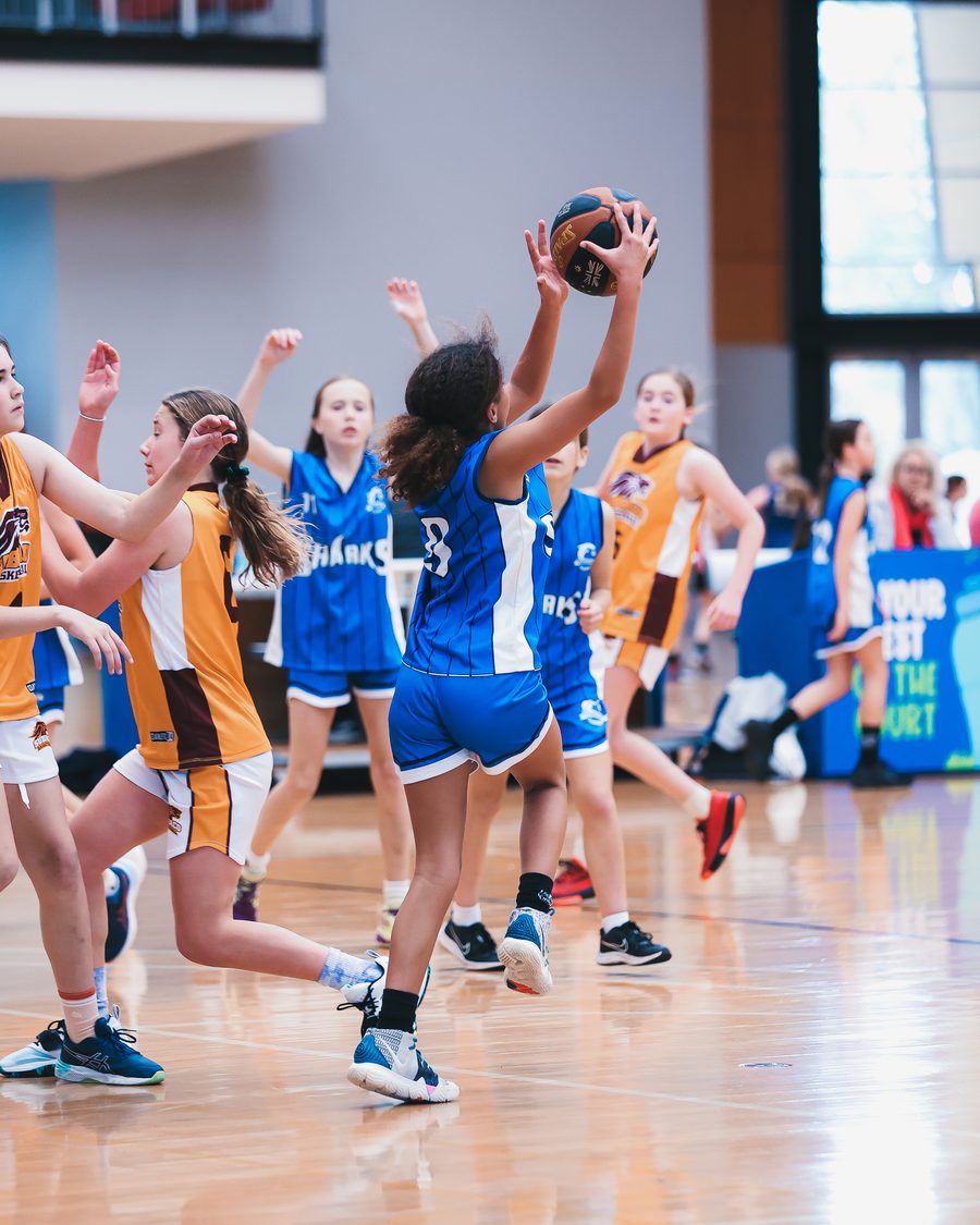 A Sharks junior driving to the basket
